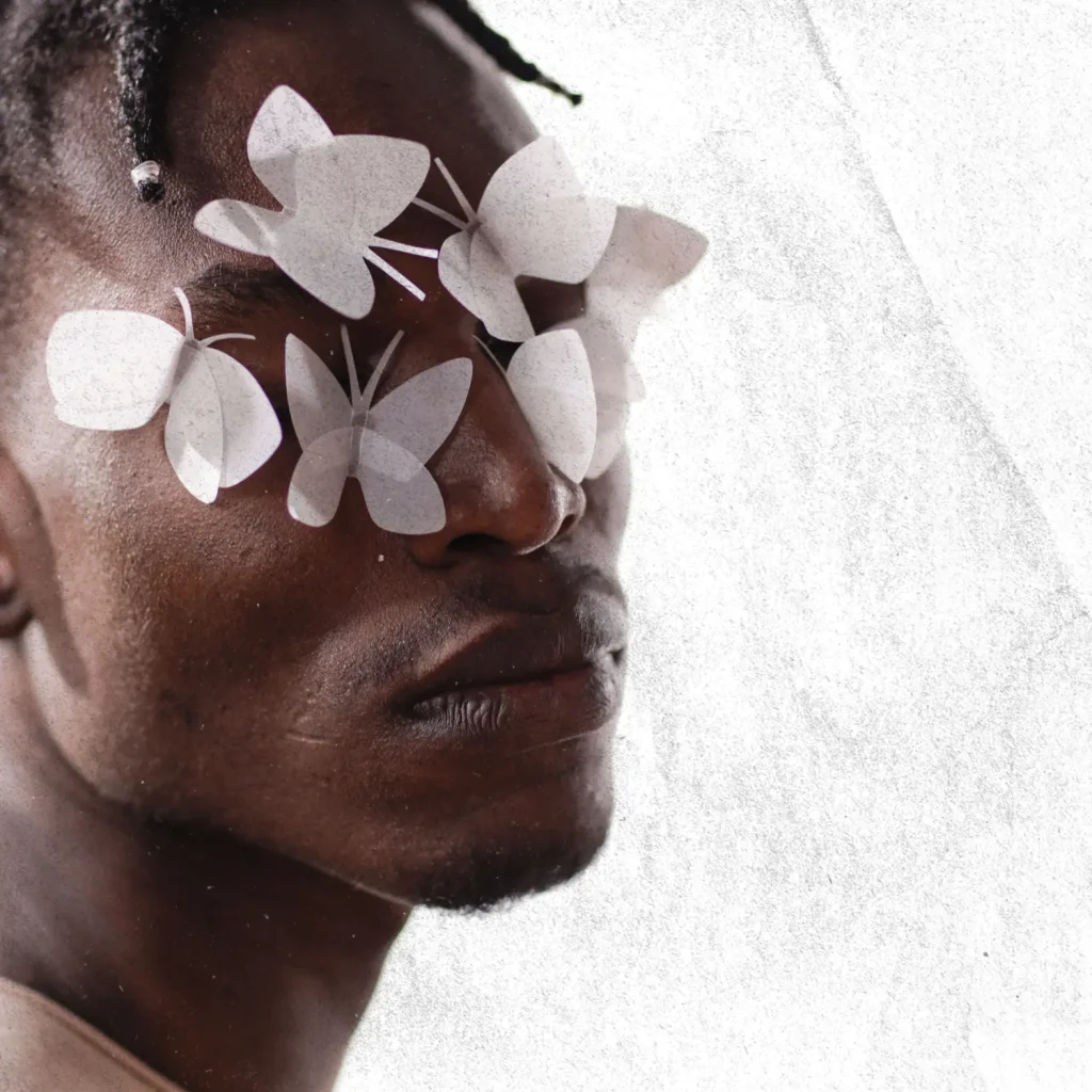 Close-up portrait of a woman with white botanical illustrations layered across her face.