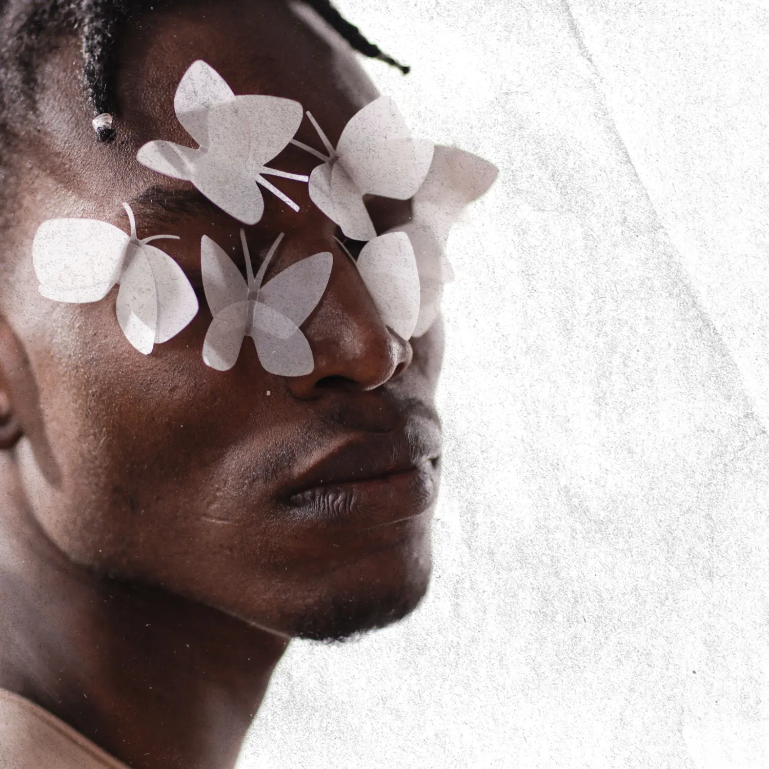 Close-up portrait of a woman with white botanical illustrations layered across her face.